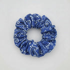 Blue bandana patterned scrunchie on a white surface